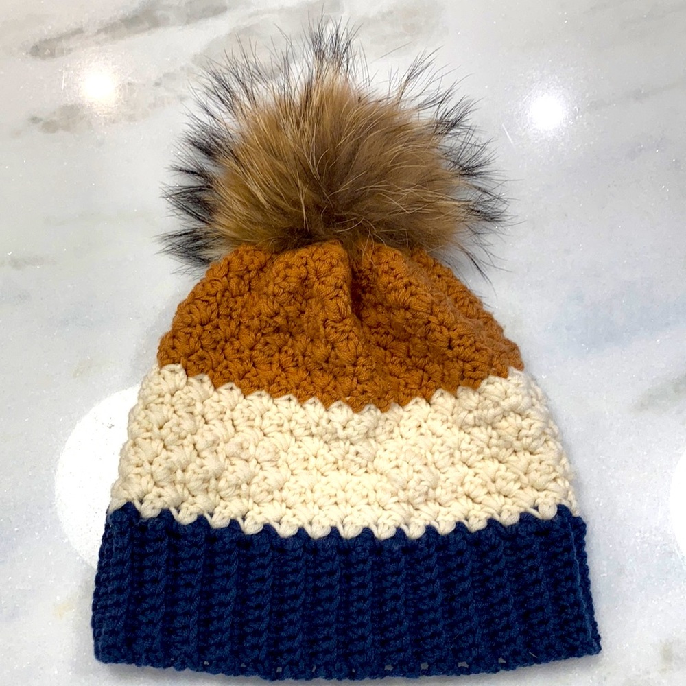 Handmade wool hat with a raccoon Pom